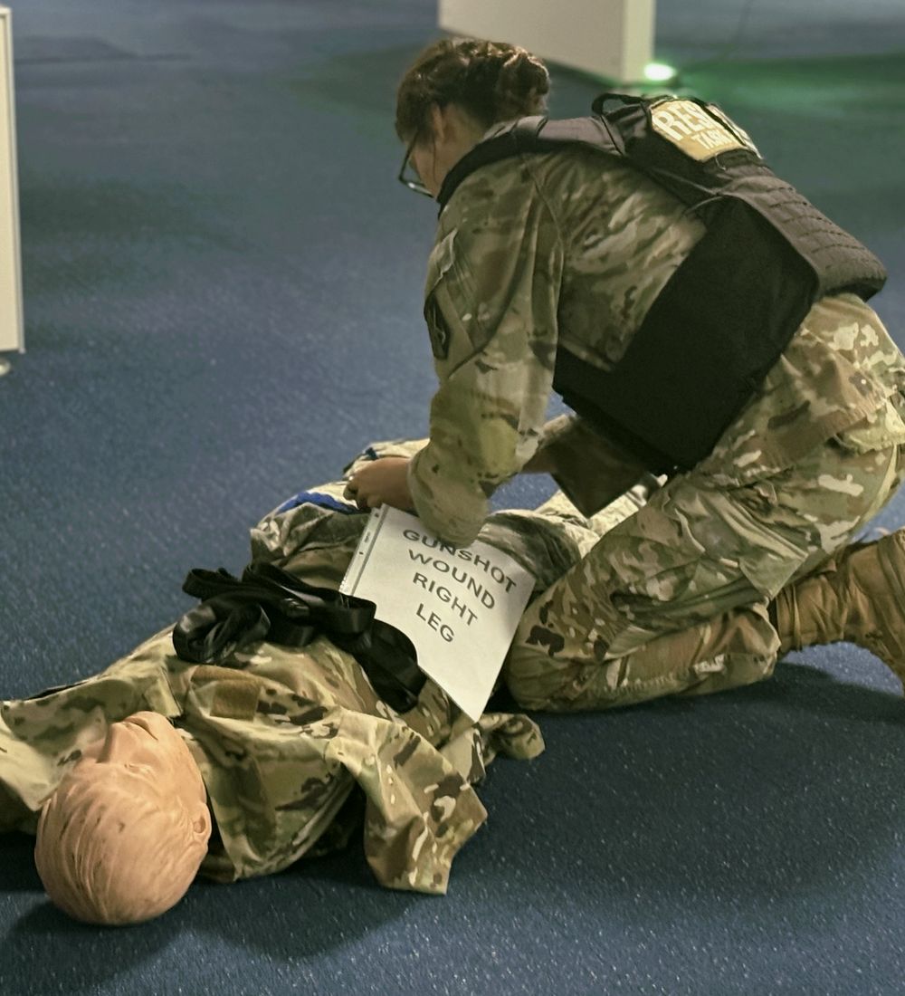 Rescue Task Force trainee applying a tourniquet to a training manikin during a scenario