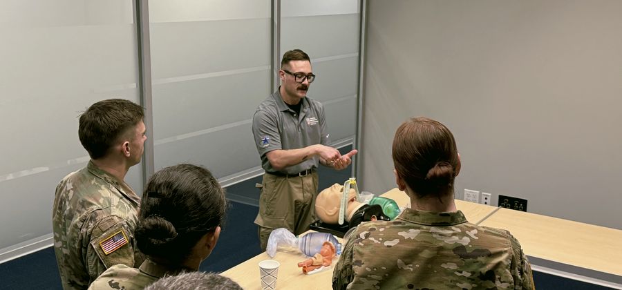 TILI instructor teaching airway management to a group of soldiers